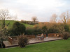 Costello-Events > In back of our B&B in Ennis was the Fergus River and this wonderful deck built literally over the river.  Fast flowing with trout jumping and the bovine reality show just across, I could sit here forever!